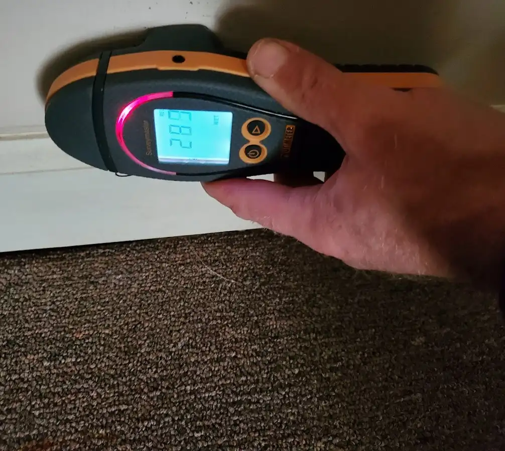Moisture detection at baseboard during Storm Damage Restoration in Sallisaw